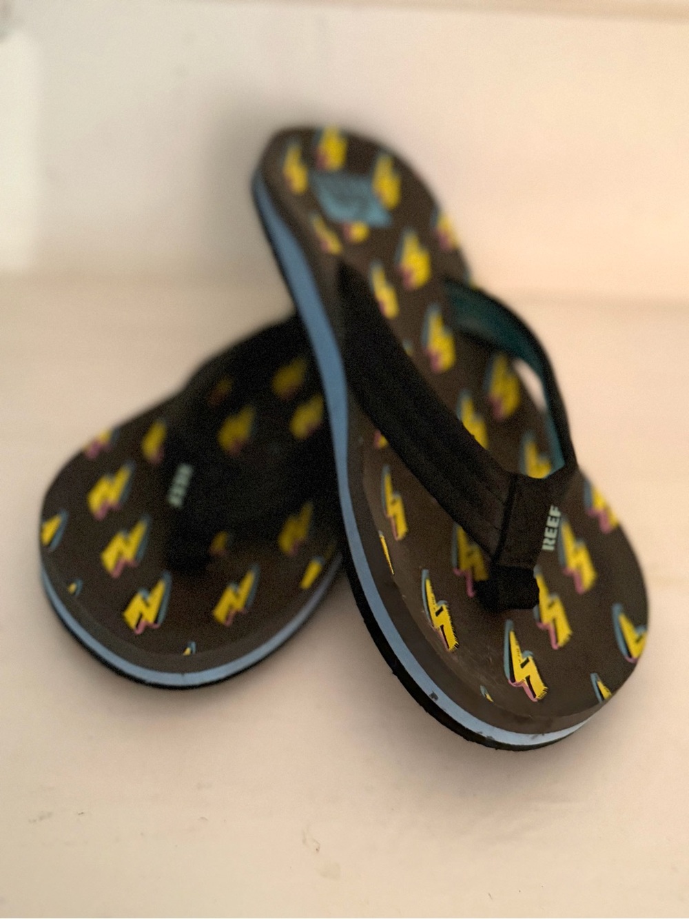 Reef Kids Black Flip Flops with Yellow Lightning Print